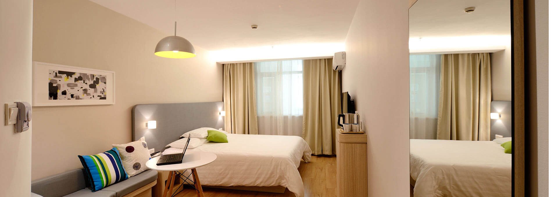 a hotel room with two beds and a desk at The Maxwell