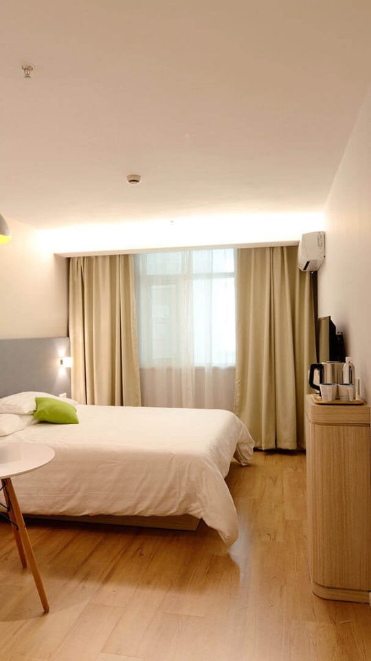 a hotel room with two beds and a desk at The Maxwell