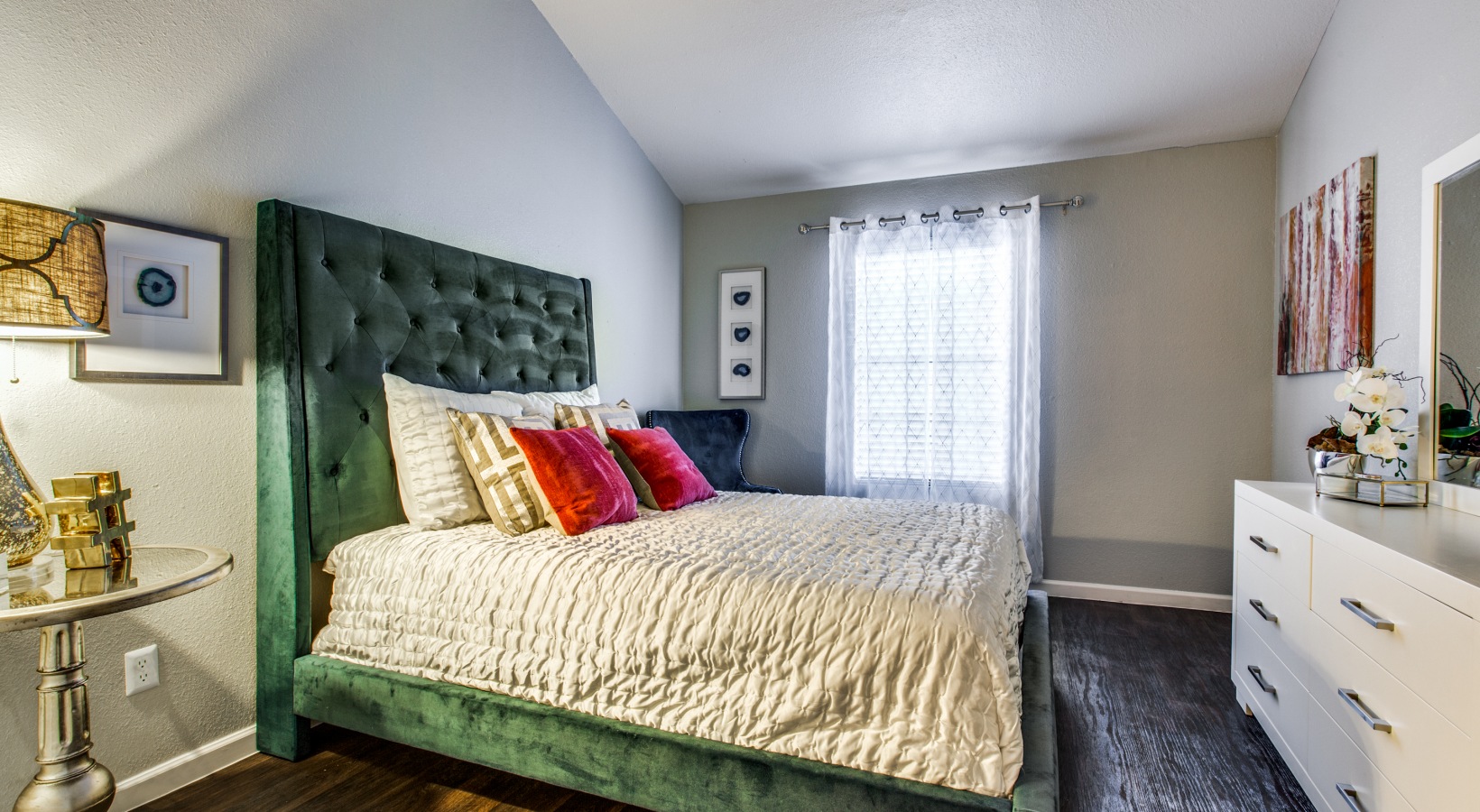 a bedroom with a green headboard and a white bed at The Maxwell