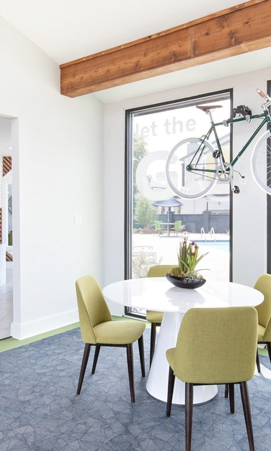 a dining room with a table and chairs and a bicycle at The Maxwell