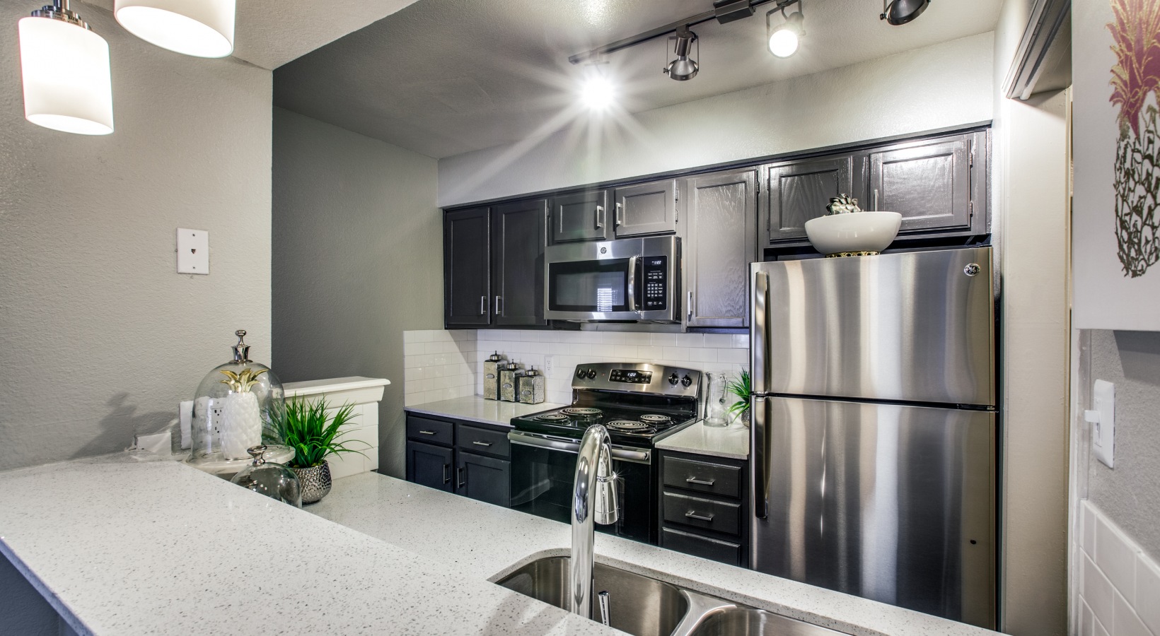 kitchen with stainless steel appliances and granite countertops at The Maxwell