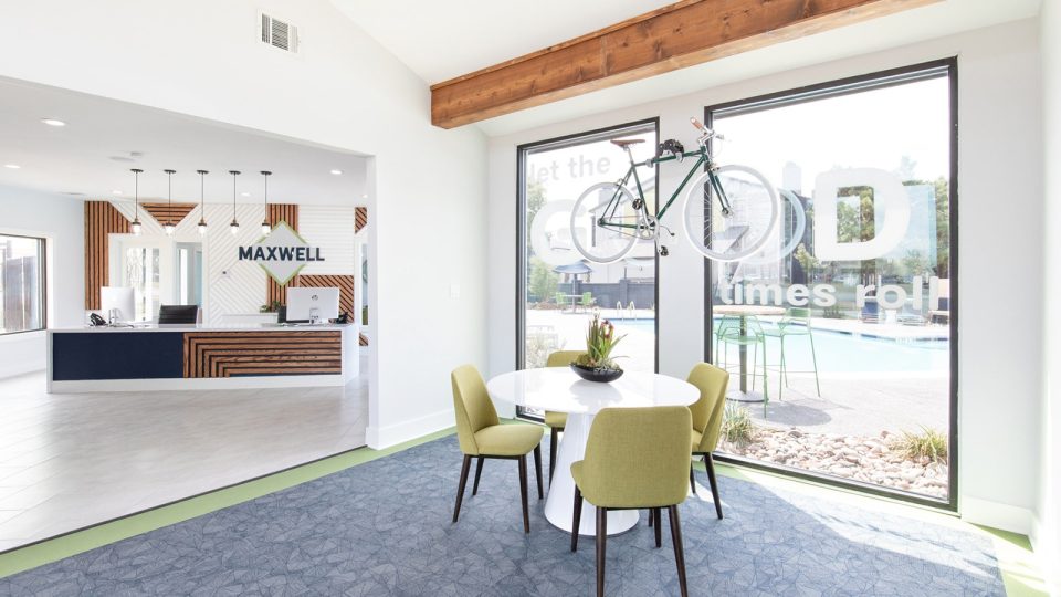 a dining room with a table and chairs and a bicycle at The Maxwell