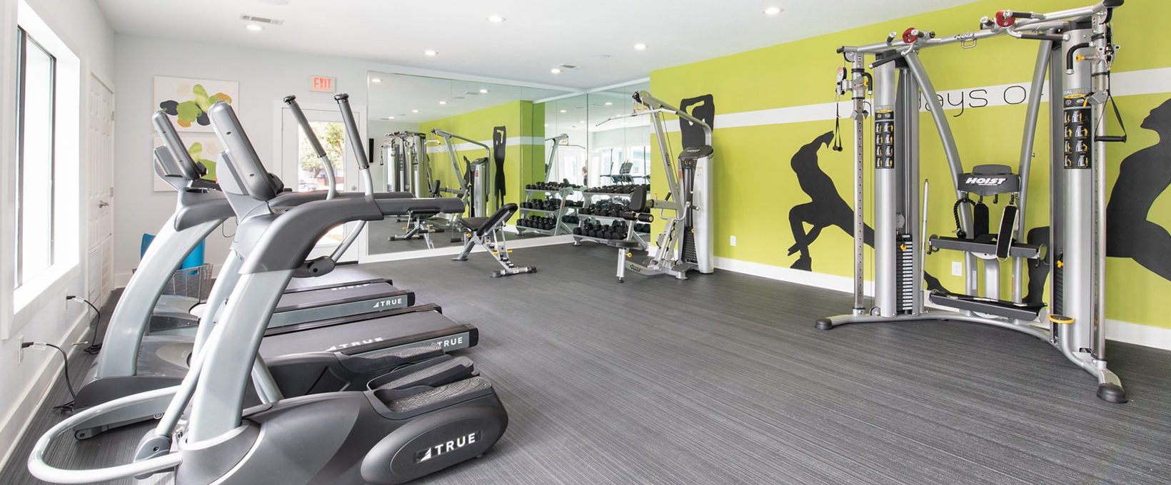 a gym room with tread machines and exercise equipment at The Maxwell