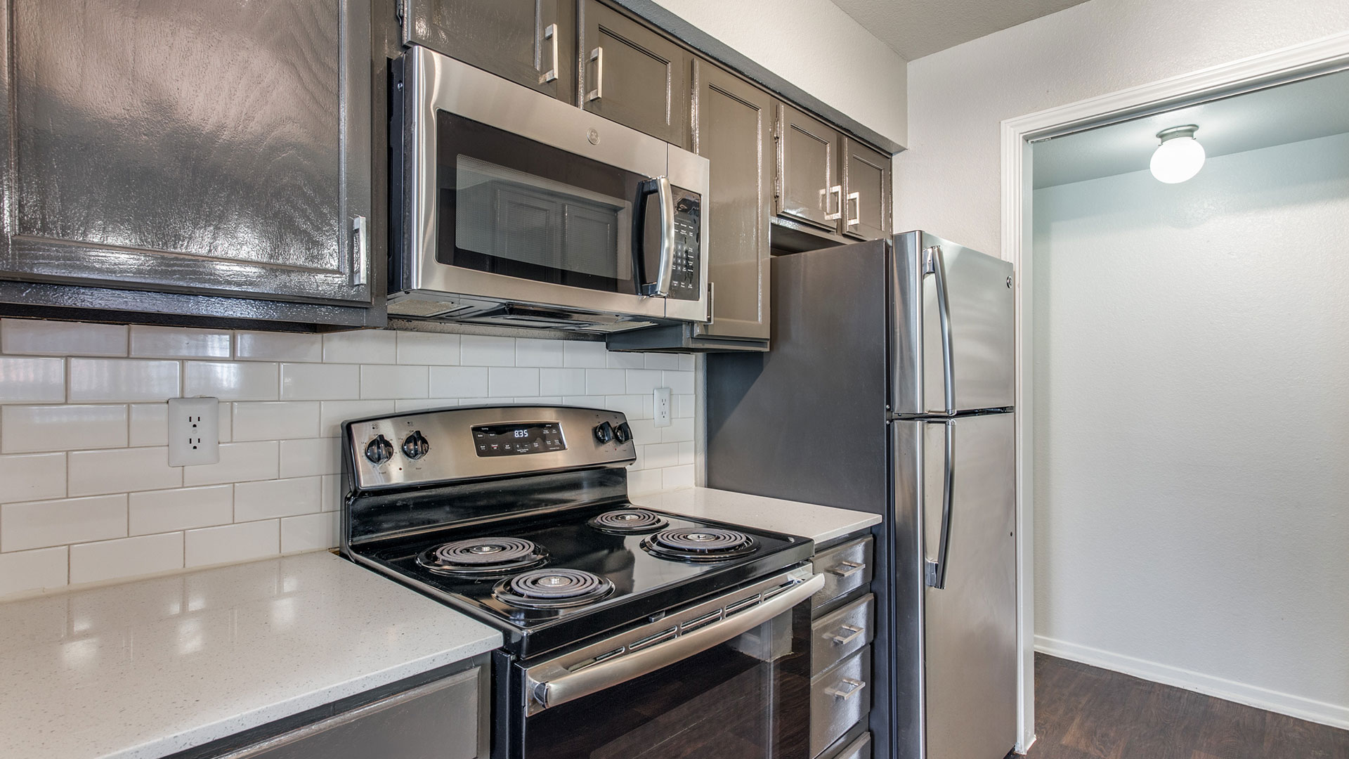 a kitchen with stainless steel appliances and a microwave at The Maxwell